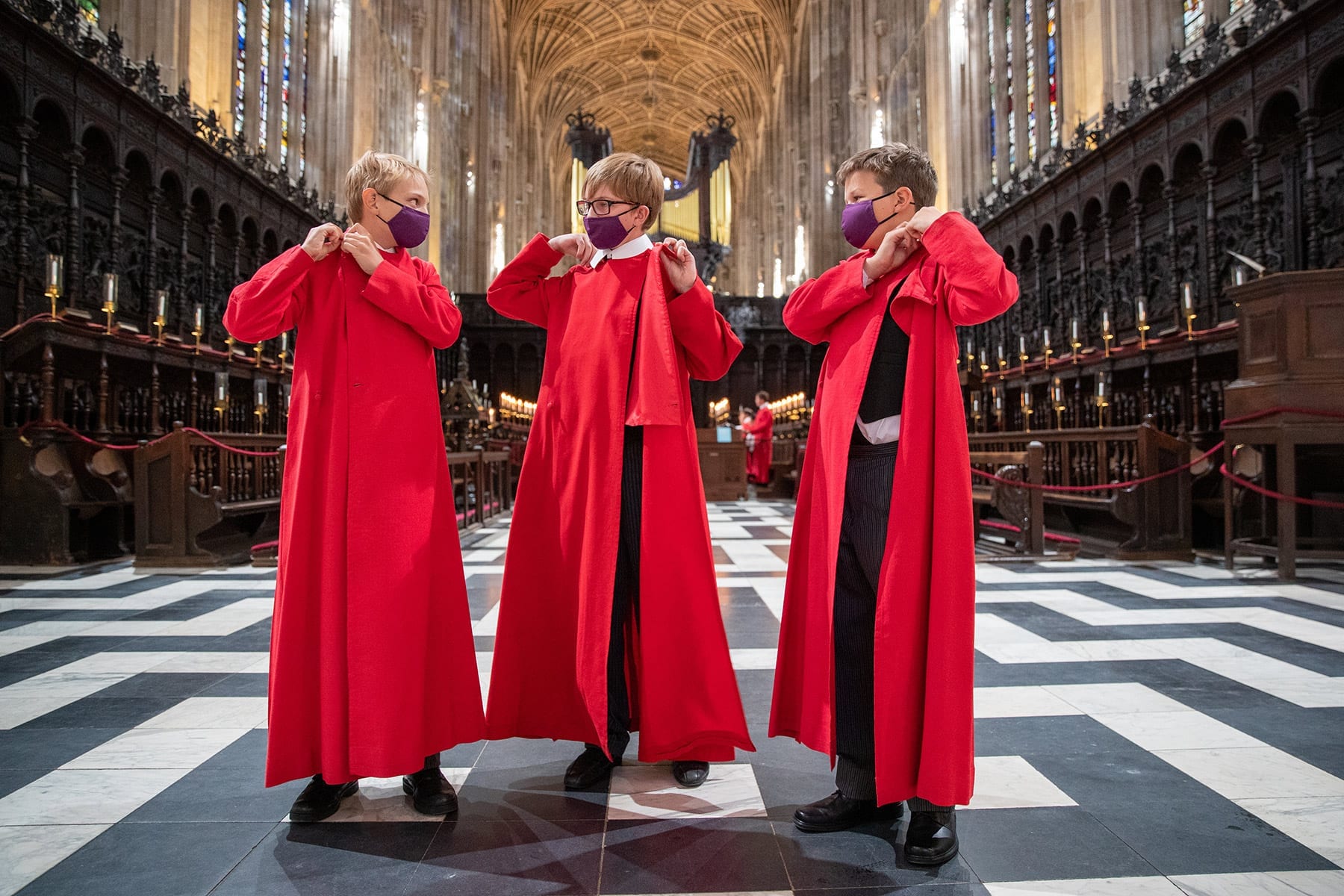 Choristers fitting their robes